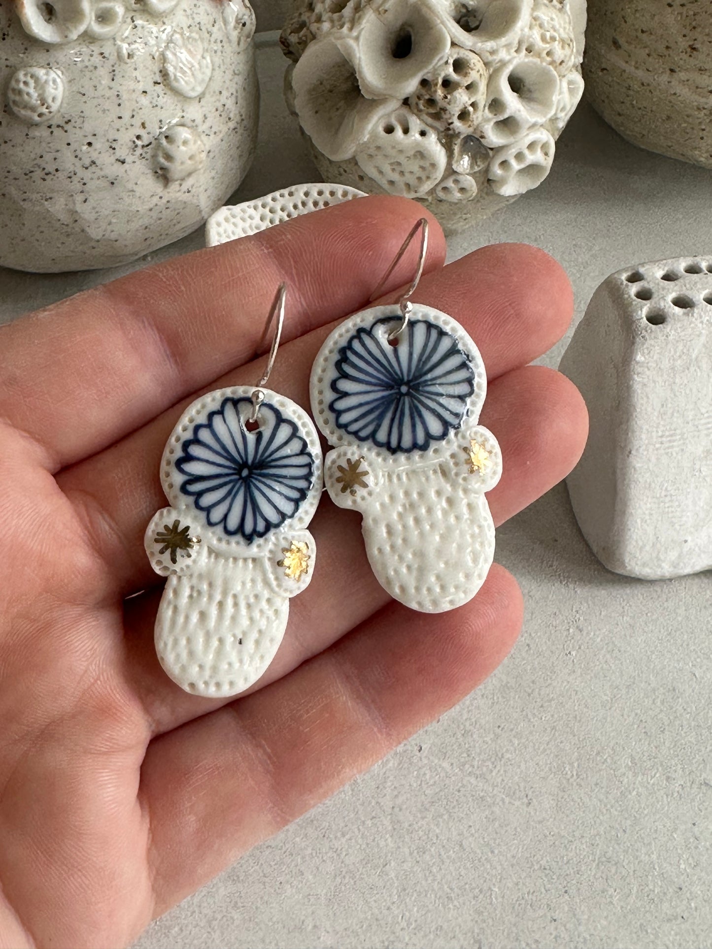 Blue and white hand painted porcelain earrings with gold lustre detail.
