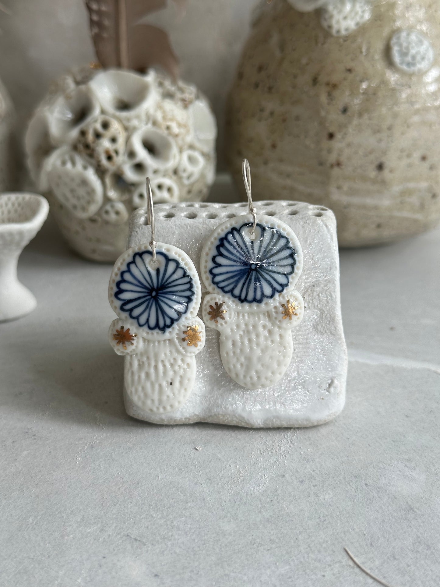 Blue and white hand painted porcelain earrings with gold lustre detail.