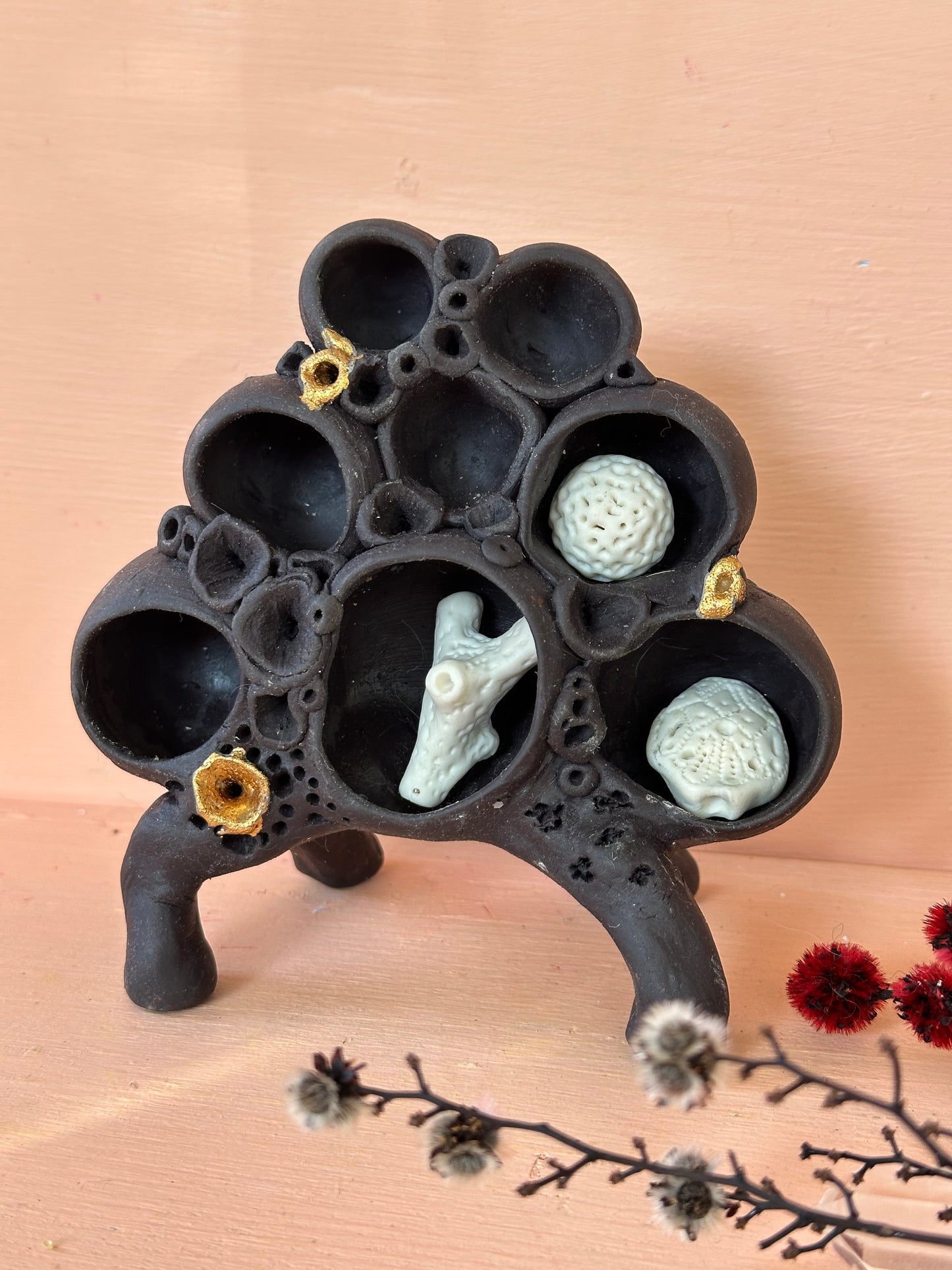 Black clay ‘treasure shelf’ with coral accents & accessories
