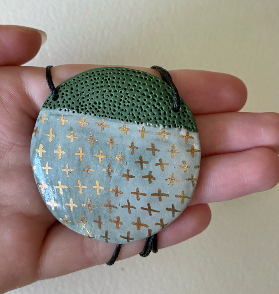 Green porcelain pendant with gold crosses