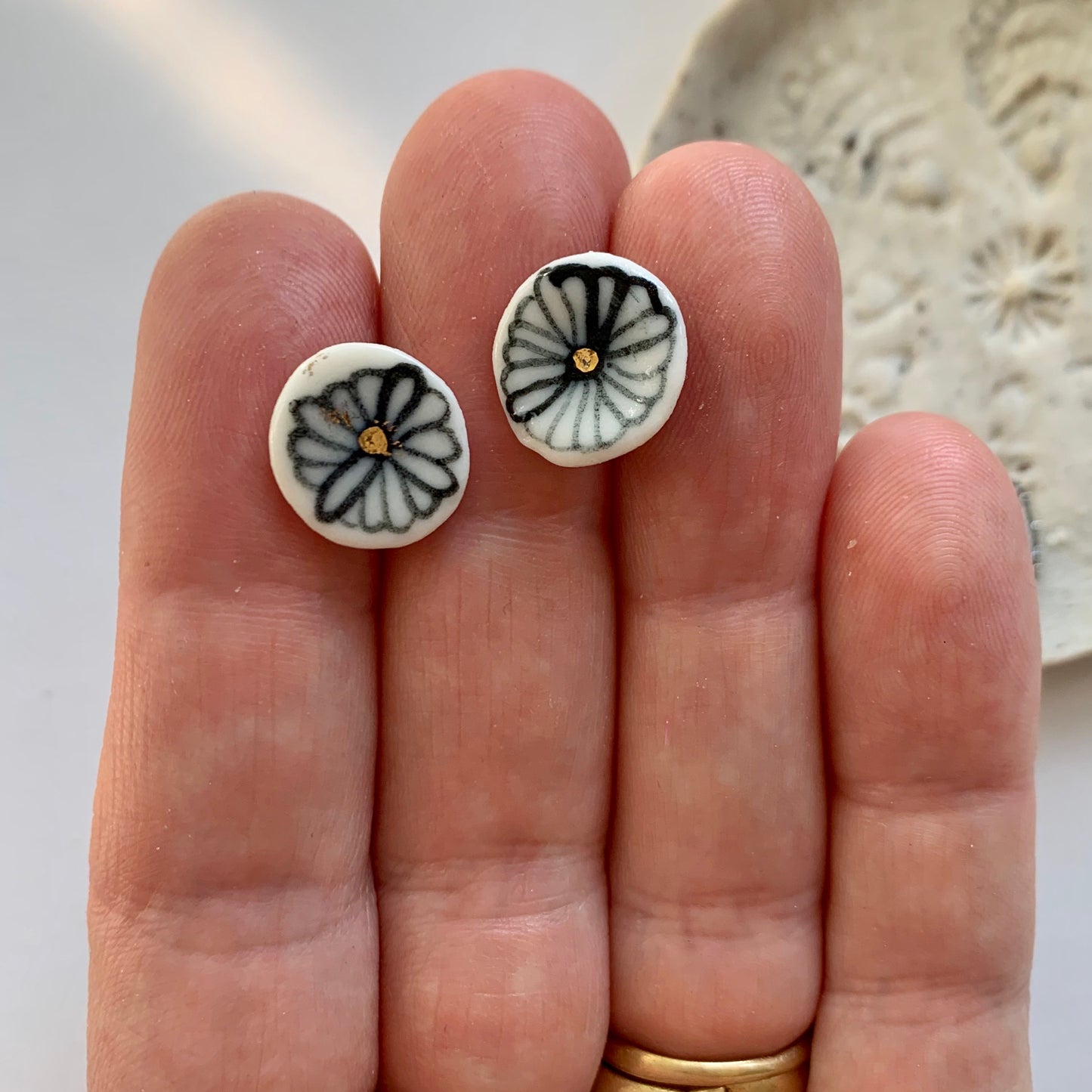 One pair of porcelain studs, blues