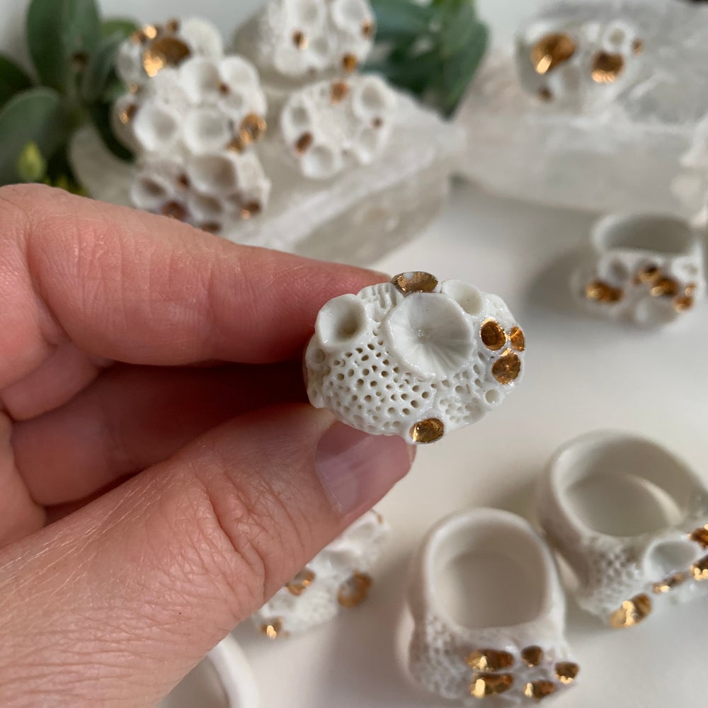 One white and gold ‘rock coral’ porcelain ring