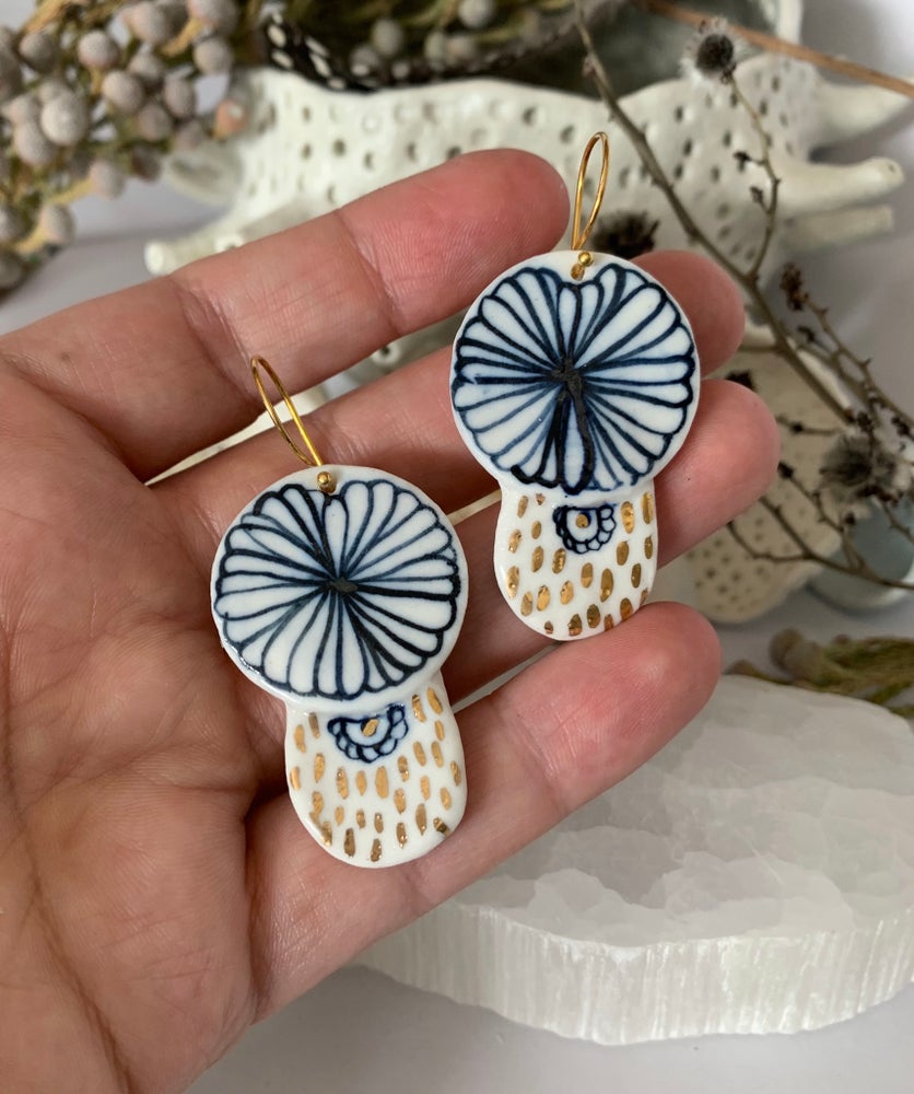 Blue and white hand painted porcelain earrings with gold lustre detail.