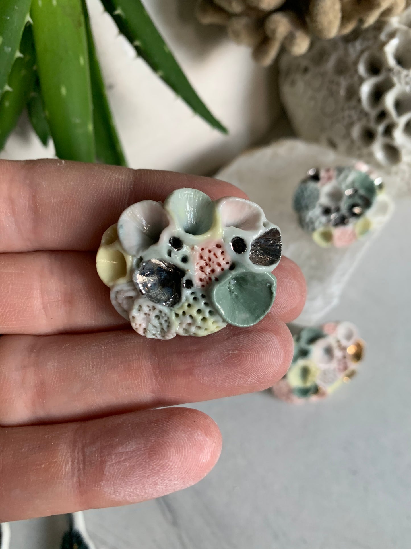 ’Rock coral’ coloured porcelain brooch, choose one